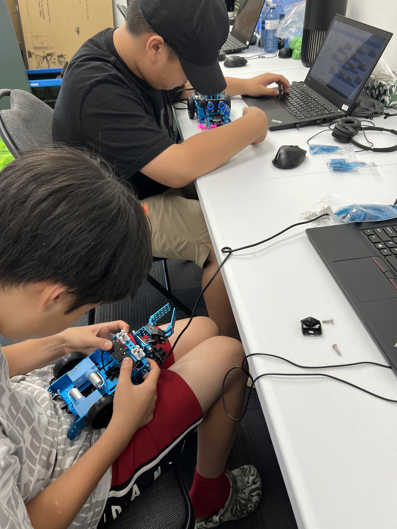 Students building and coding robots together