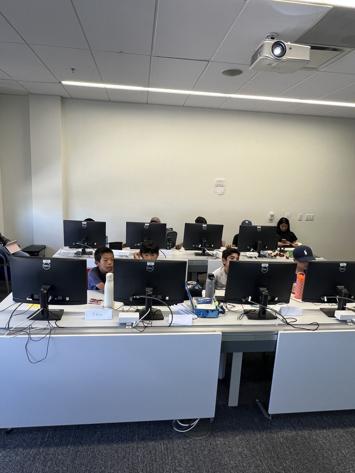 Students coding at rows of desktop computers in the CodeSky lab