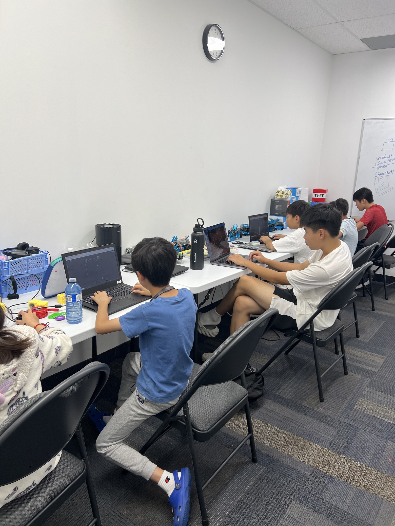 Students coding on laptops during class